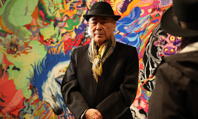 Yoshitaka Amano at the exhibition opening &mdash; the artist viewing original works spanning five decades of his career