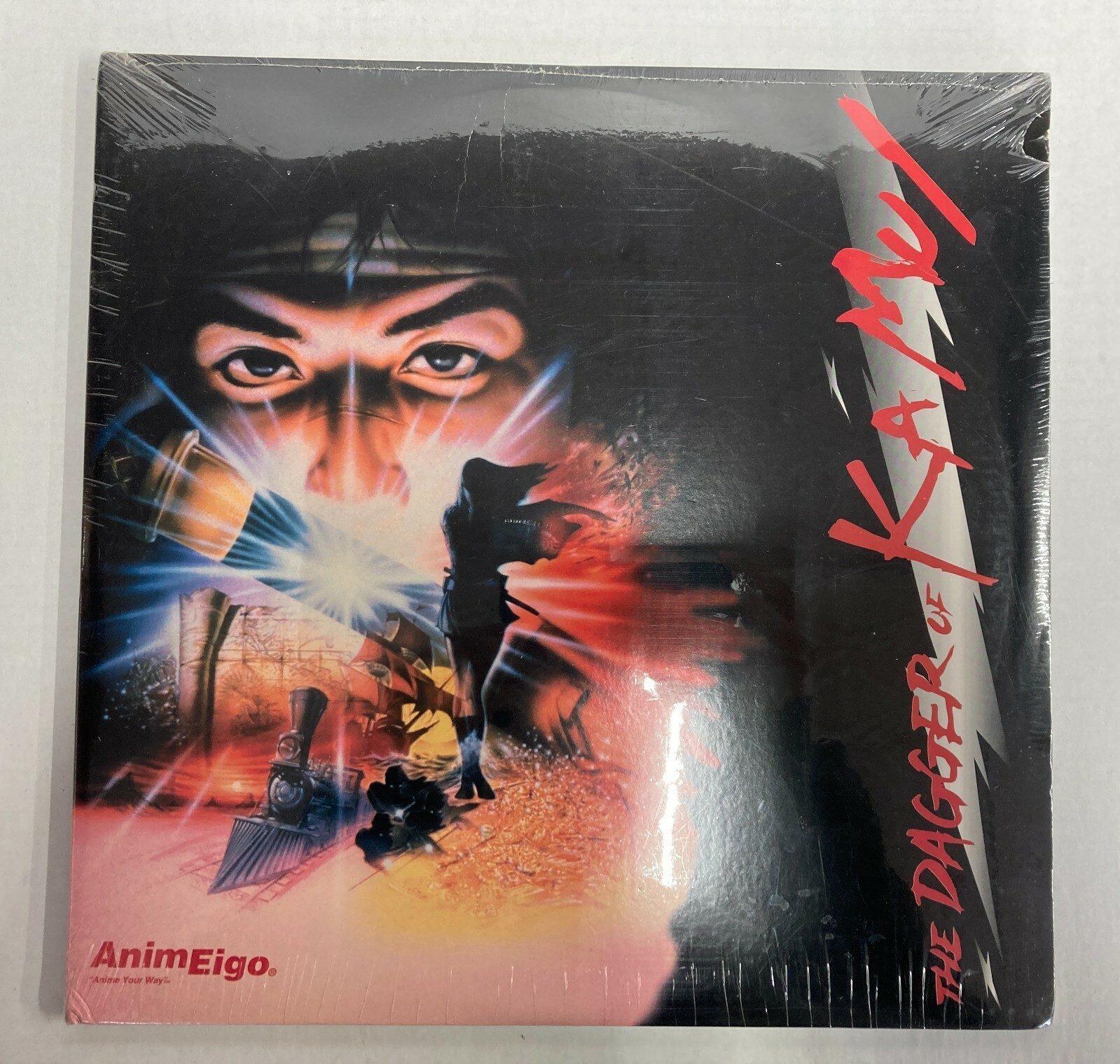 AnimEigo US LaserDisc release — 1990s, English subtitles. Entirely different key visual: red diagonal title treatment against a darker composite. The AnimEigo logo, lower left. This is the release Western collectors know. Still sealed.
