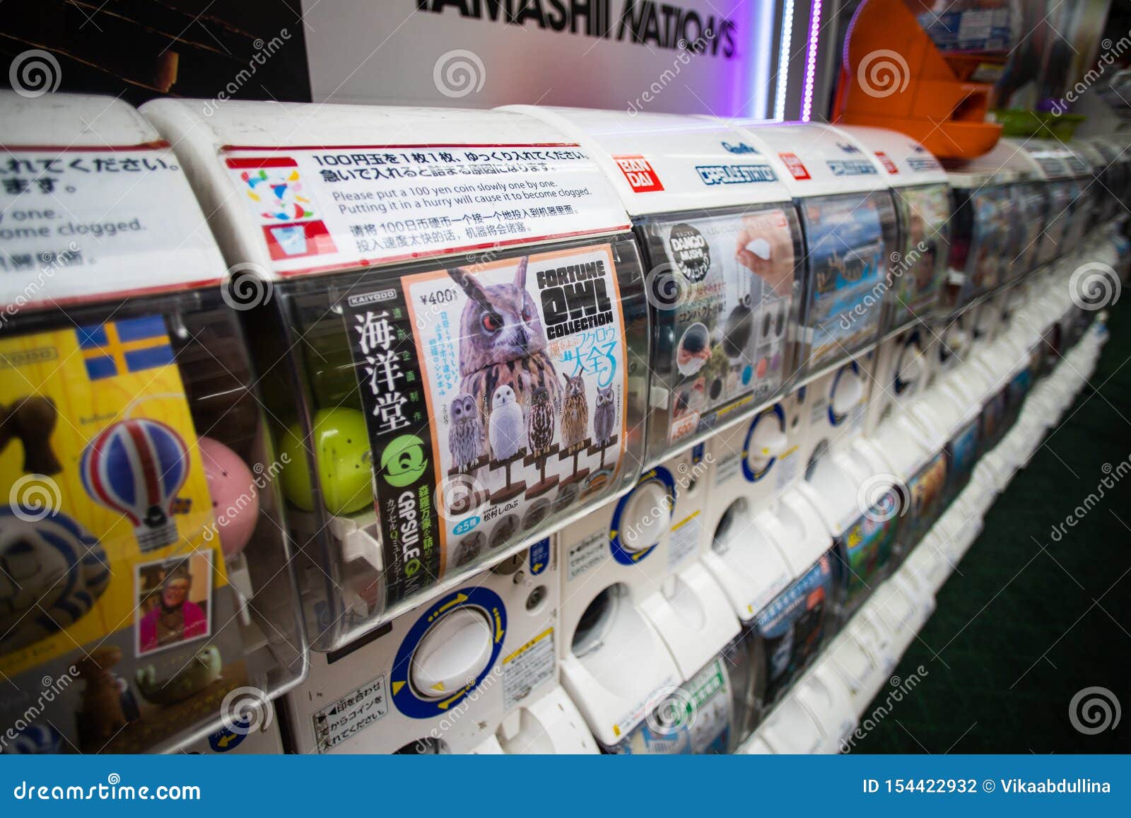 Capsule Stations near Shinjuku — commercial hardware in a public bank. Each display card is a different collection. This is the equipment you can import