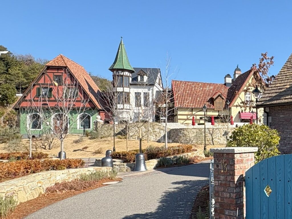 Valley of Witches streetscape &mdash; European half-timbered buildings housing the area's shops and attractions, stone walls and clay tile roofs
