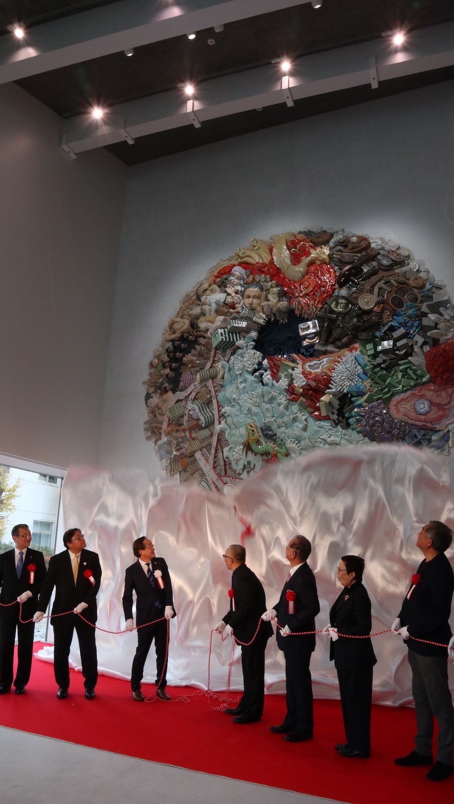 Officials and the artist at the unveiling ceremony &mdash; the silk drape pulled away to reveal the composition for the first time
