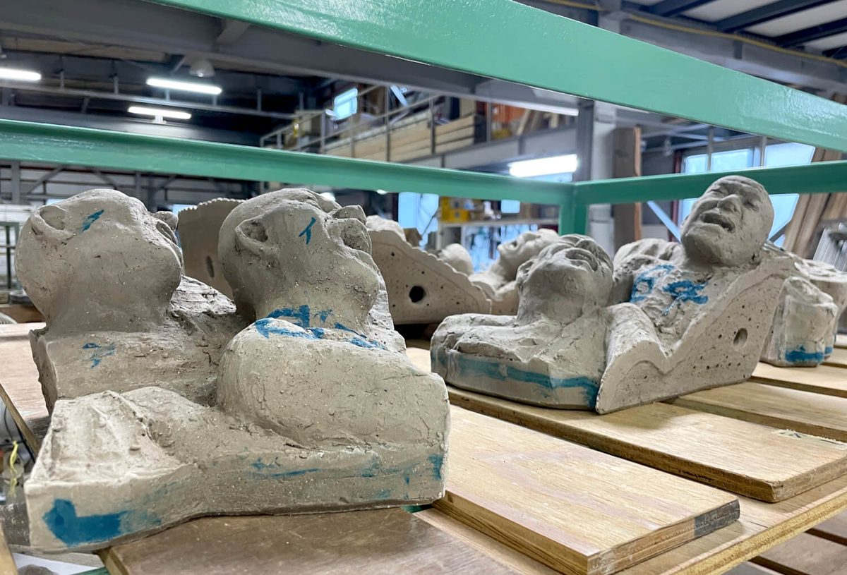 Unfired ceramic faces and figures awaiting the kiln