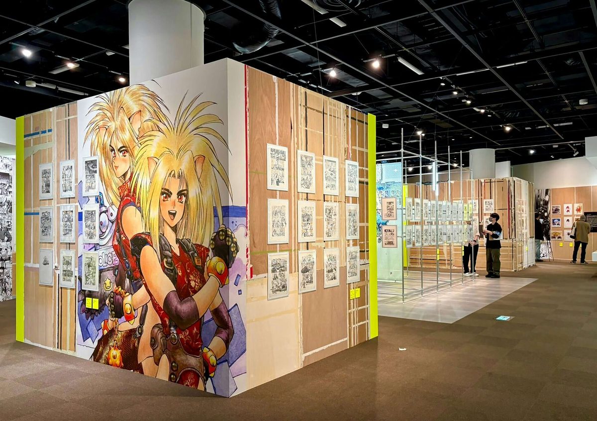 Exhibition overview &mdash; Setagaya Literary Museum's main hall featuring large-format Appleseed character illustrations and manuscript grid displays