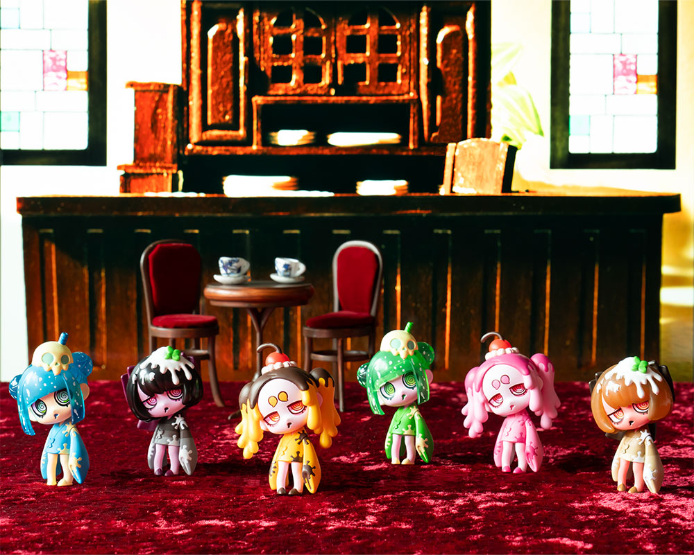 The full first-wave cast gathered at a miniature cafe. Collectors build dioramas like this — the figures chatting together at night.