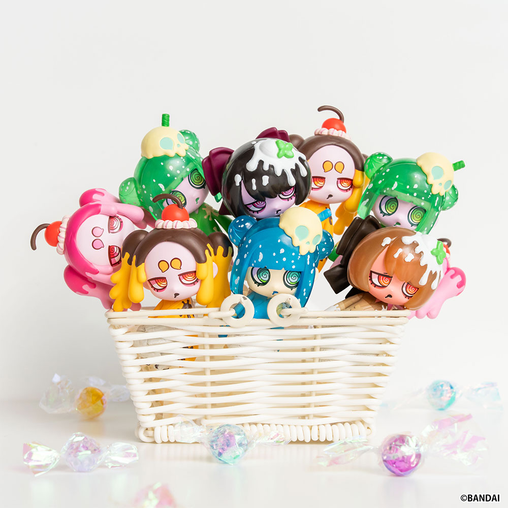 Figures arranged in a wicker basket with scattered sweets. The material work is visible at this scale — clear resin fizz, gradient bean-paste paint, pearl-finish ornaments.